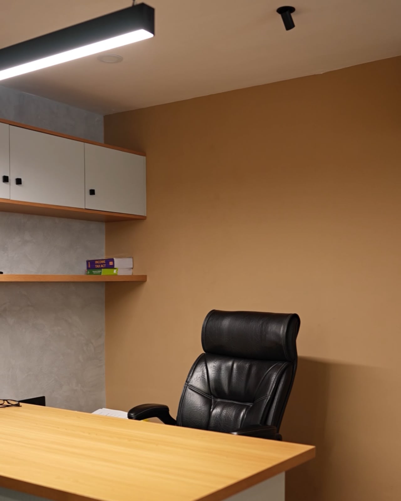 Sabu CS & Company — Principal's cabin — leather high-back with the Income Tax Act on the ledge