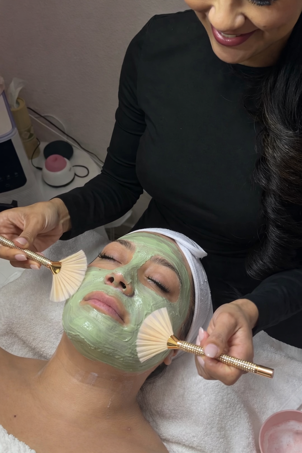 Jaymie performing a facial treatment