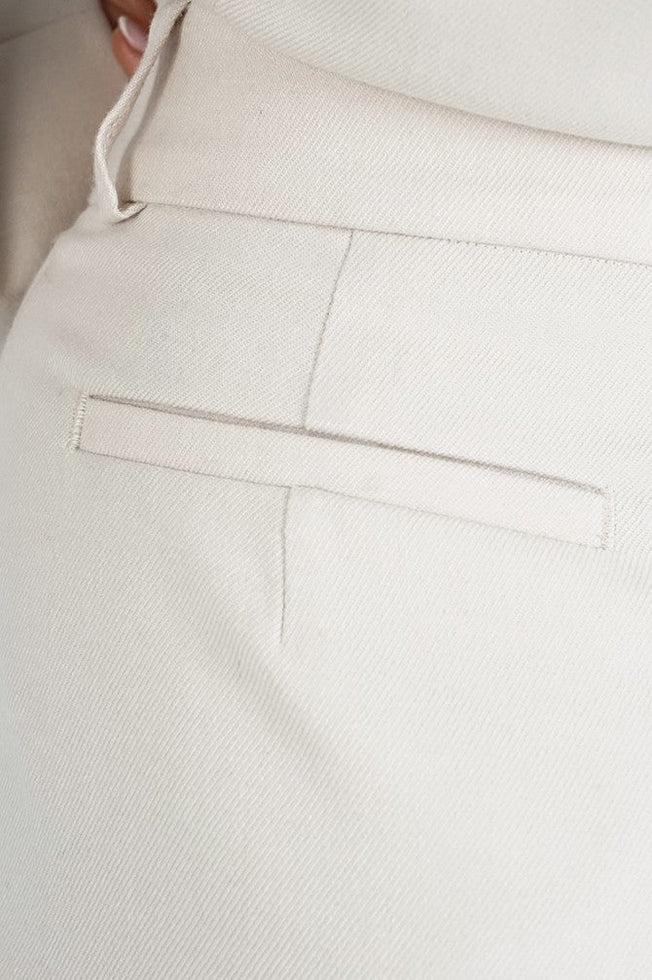Close-up of good white trousers with a matte, even fabric and neat fake front pocket