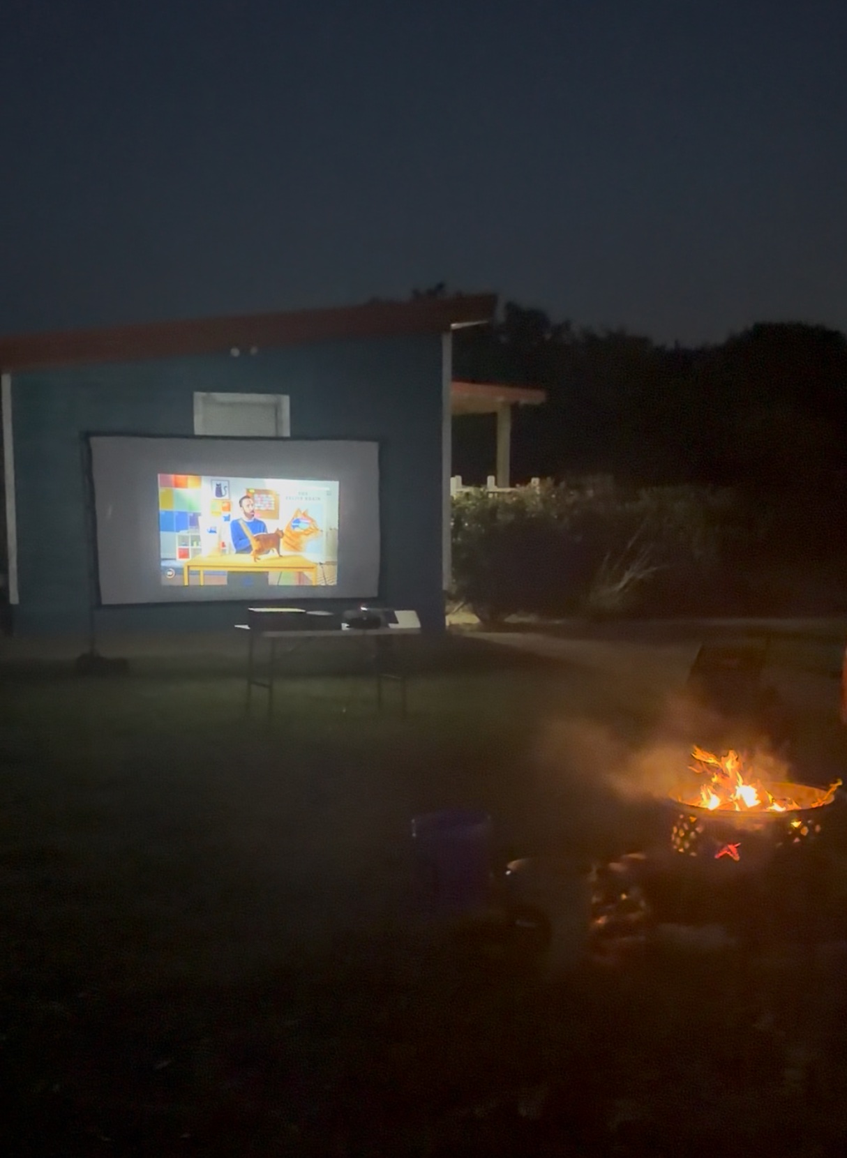Outdoor movie night by the campfire
