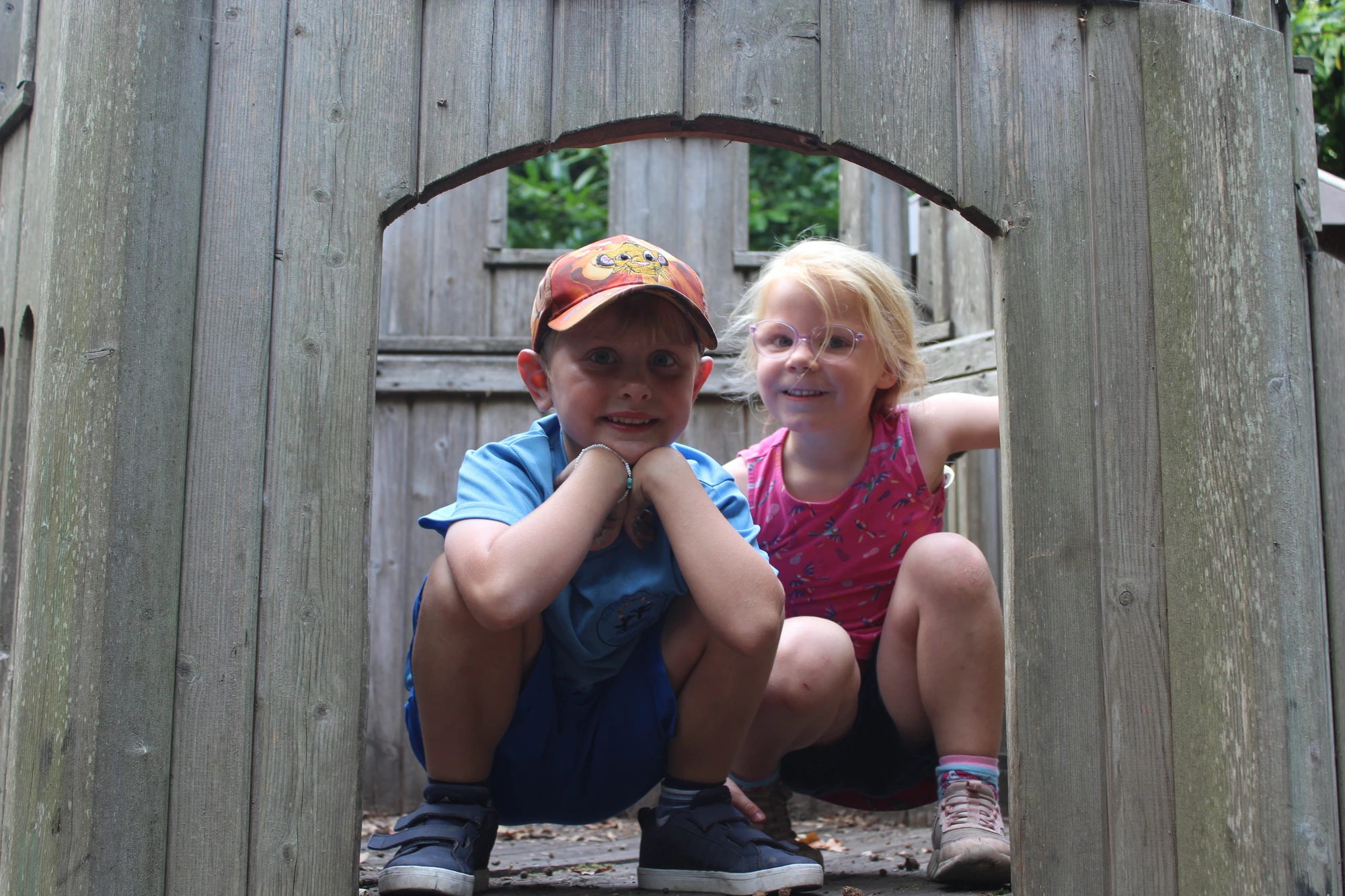 Two campers enjoying the woodland play area