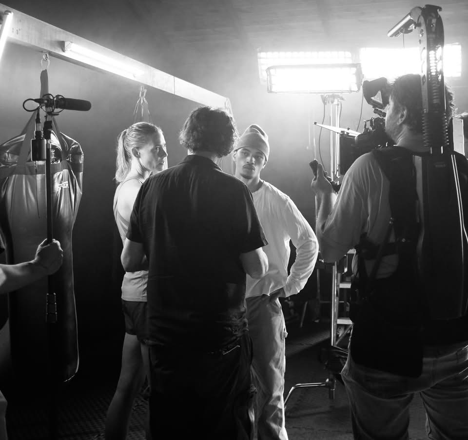 Director briefing cast · backlit haze